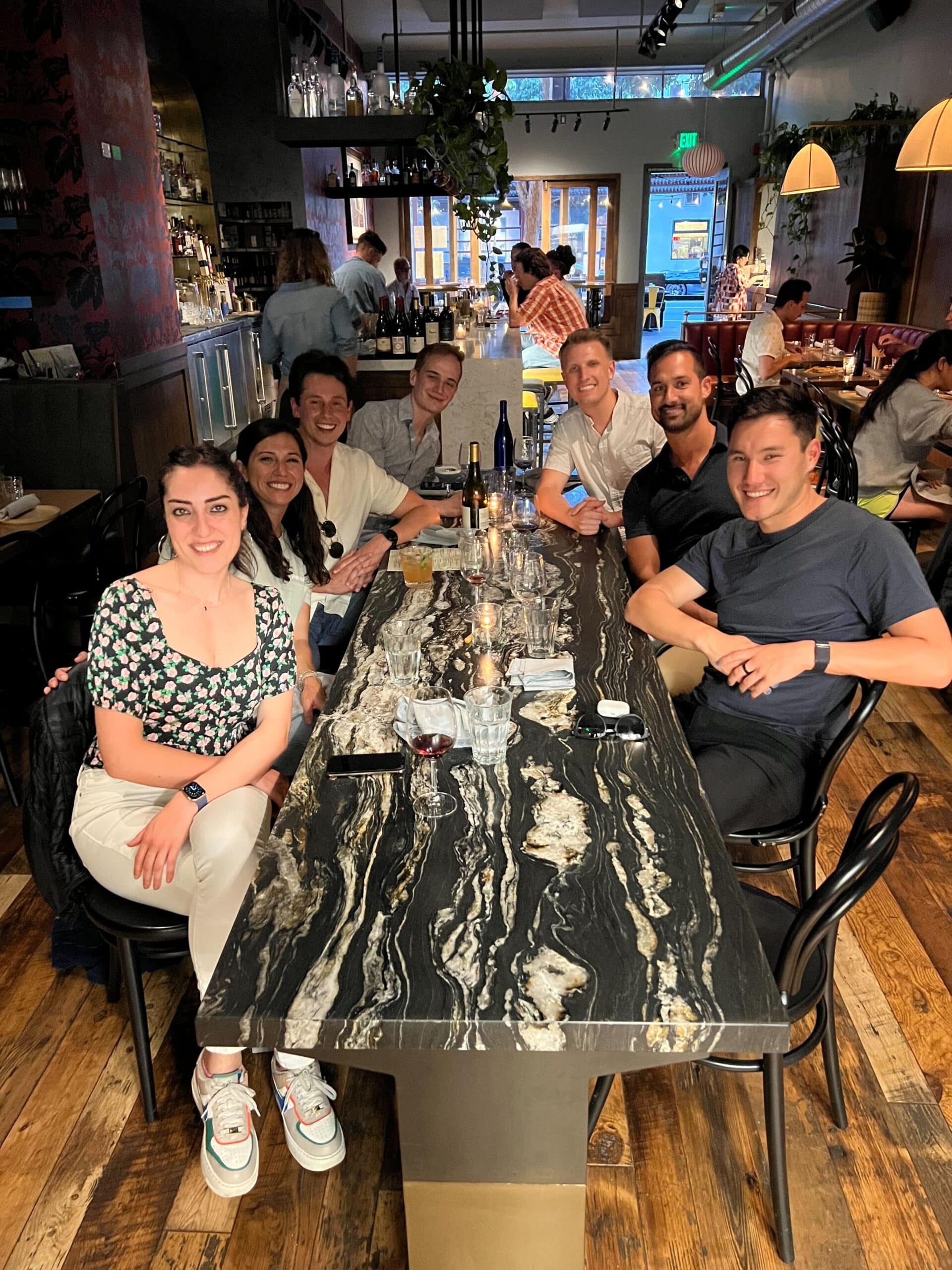 Image of seven Branch team members posing at a dinner table.