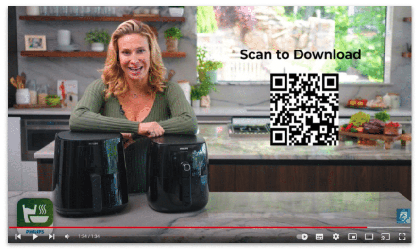 Still of a YouTube video for a Philips countertop cooking machine with the option to scan a QR code to download the app.