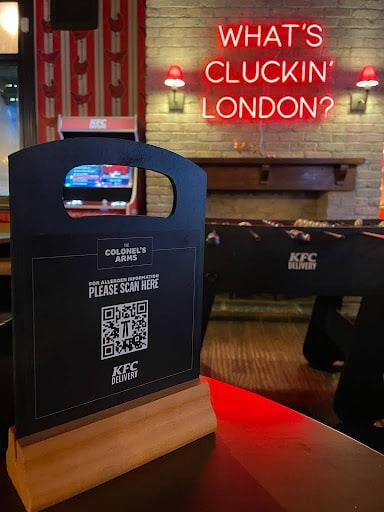 KFC QR code displayed on a menu holder. 